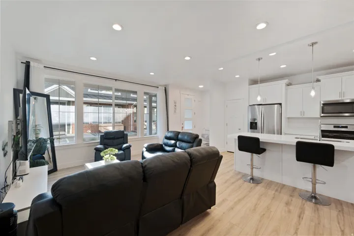 Living room featuring light wood-style floors and recessed lighting