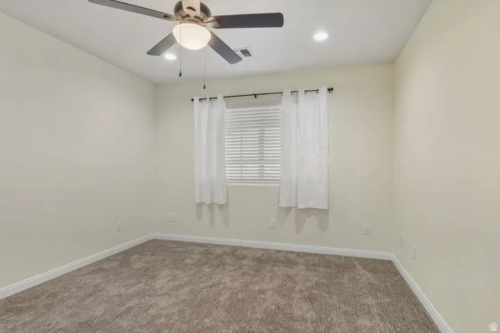 Unfurnished room with carpet floors, ceiling fan, and recessed lighting
