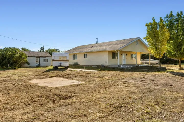 Rear view of property featuring covered porch