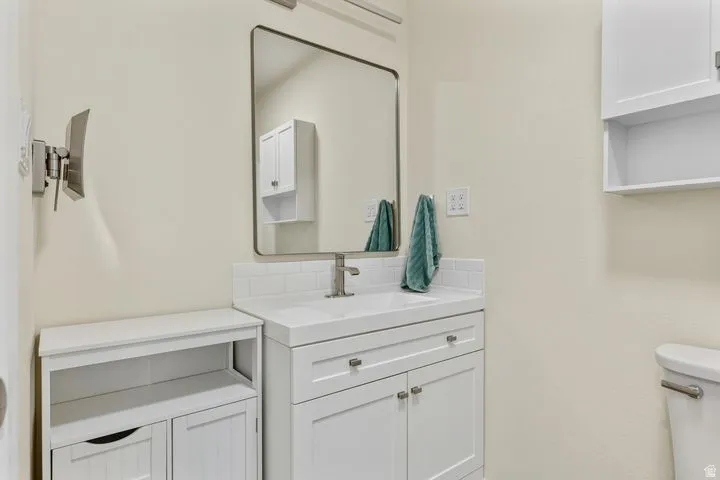 Half bath featuring vanity and toilet