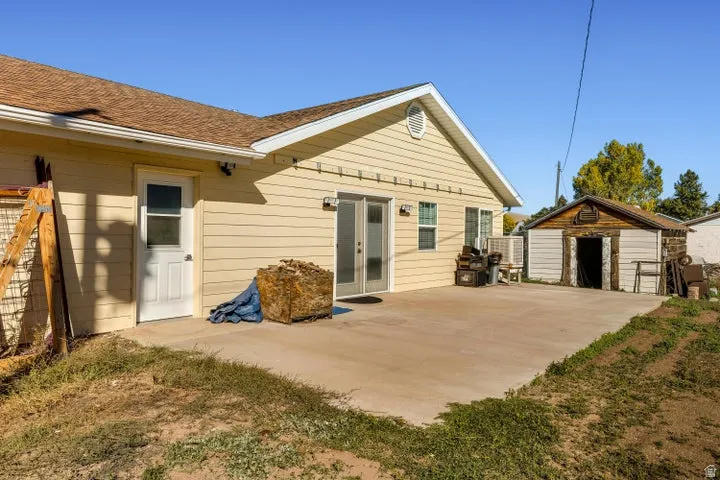 Rear view of property with an outdoor structure