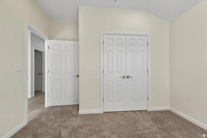 Unfurnished bedroom with carpet floors and a closet