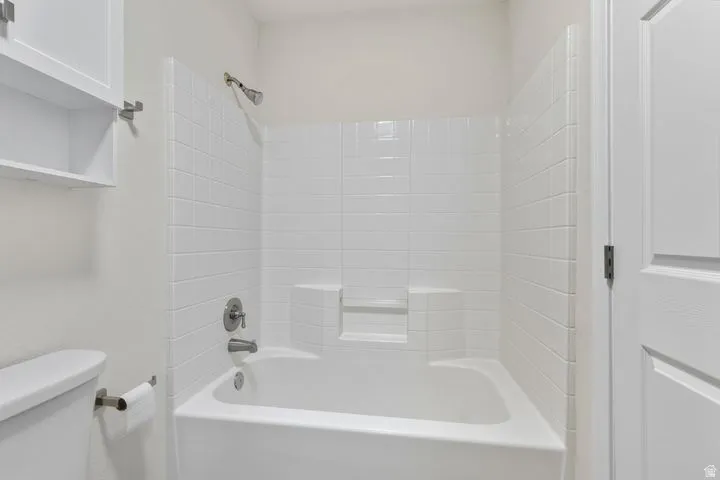 Full bathroom with toilet and shower / tub combination