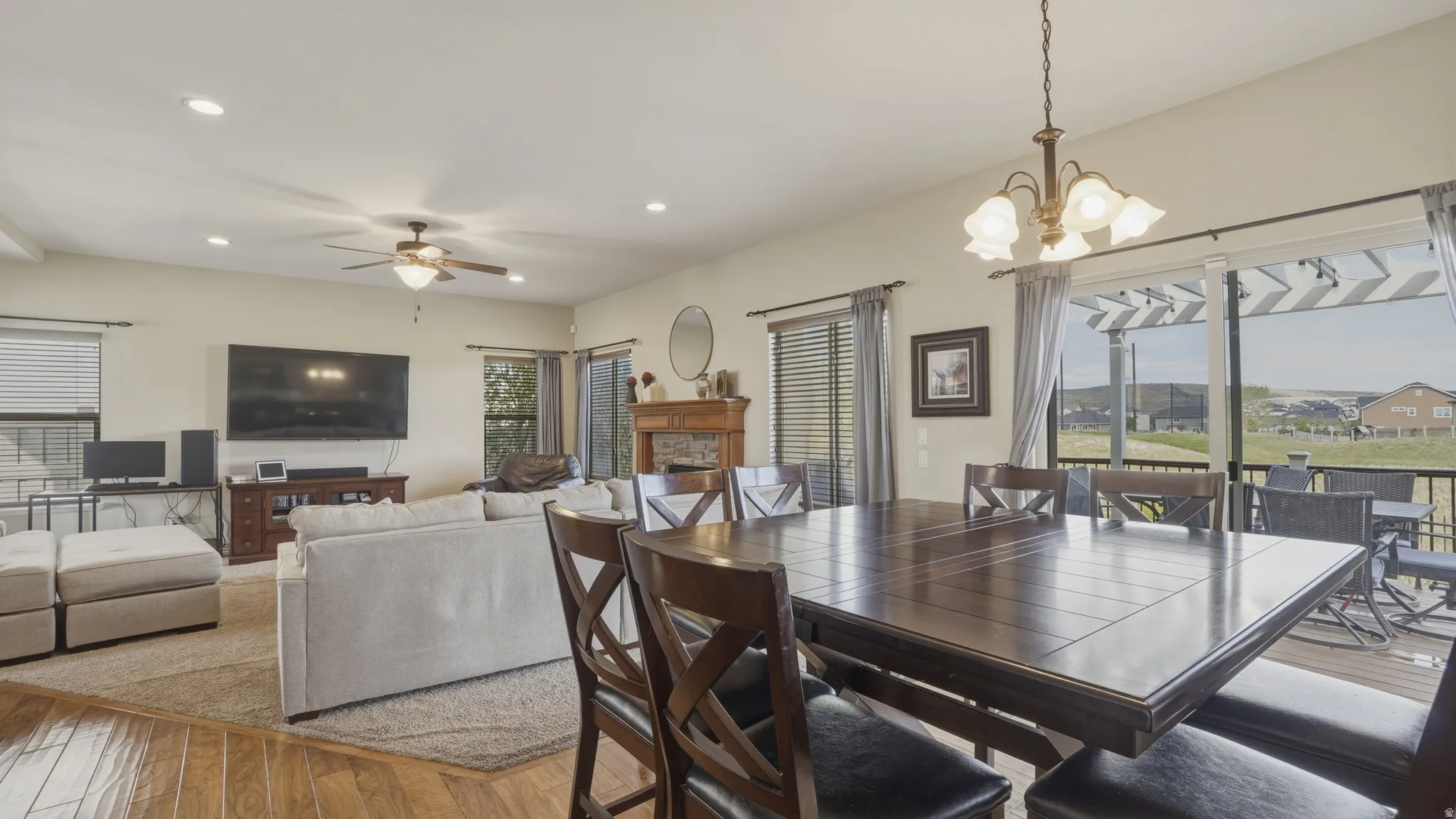 Dining space featuring light wood finished floors, a chandelier, and ceiling fan
