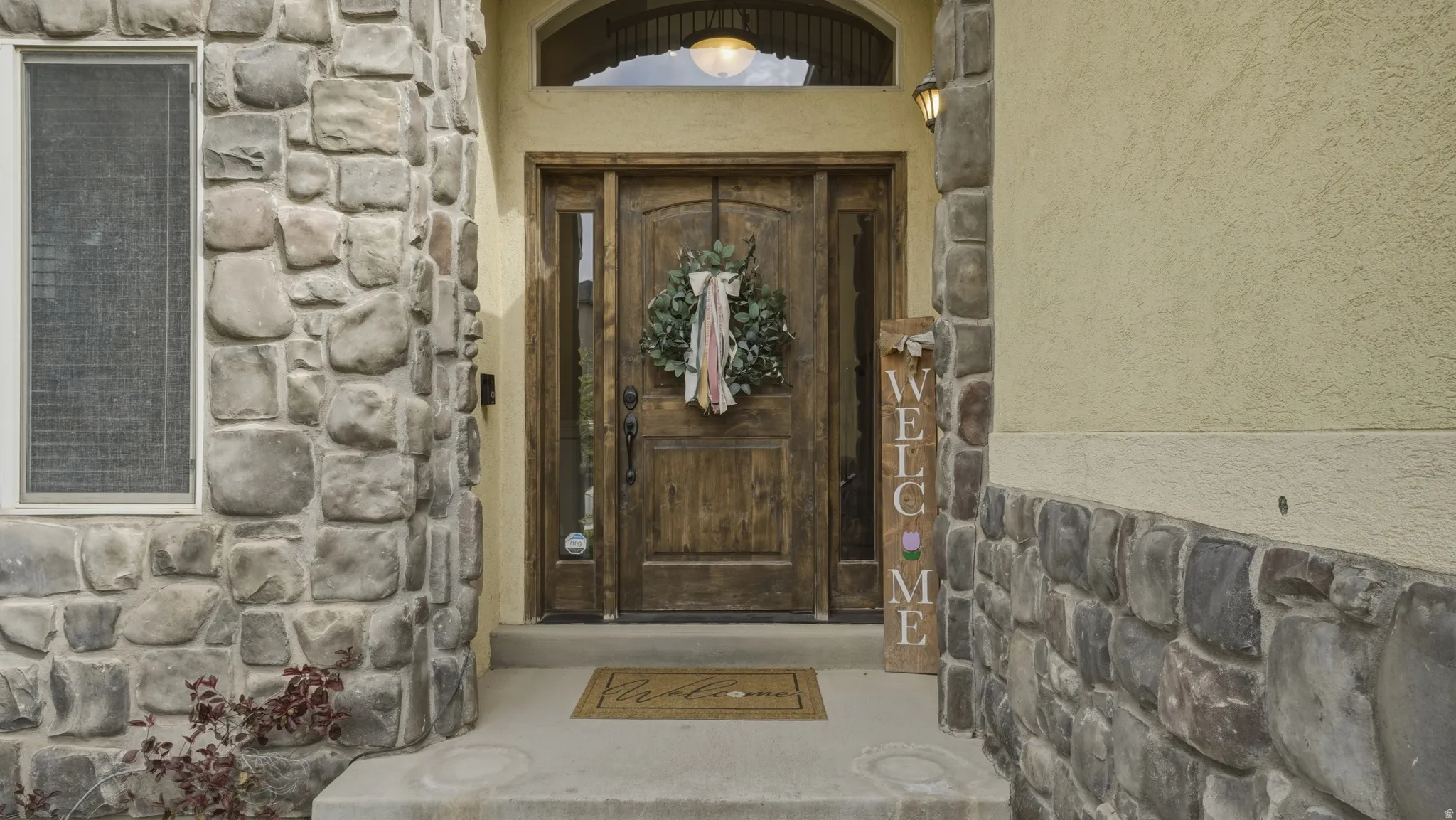 Entrance to property featuring stucco siding