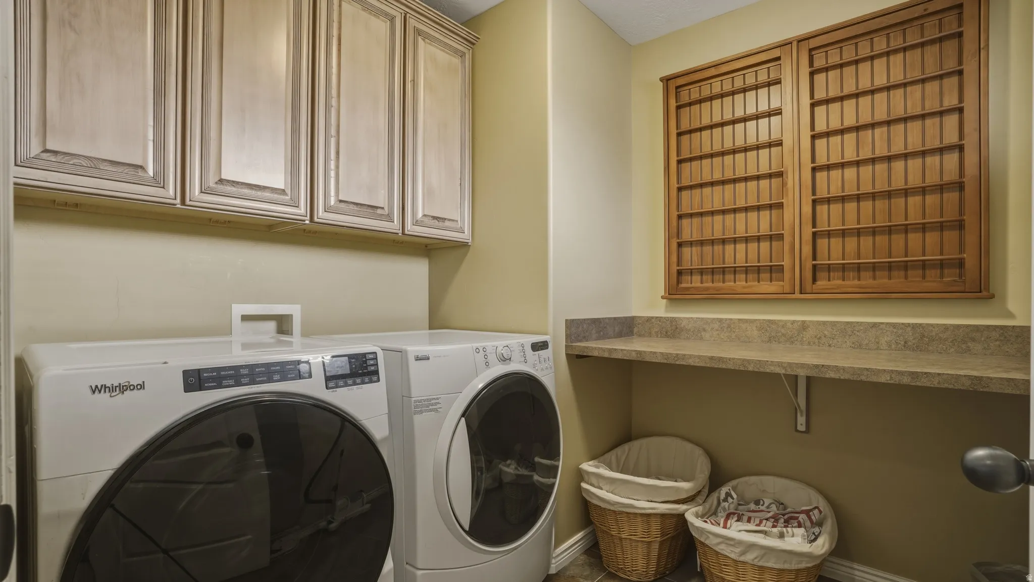 Laundry room featuring cabinet space and washing machine and clothes dryer