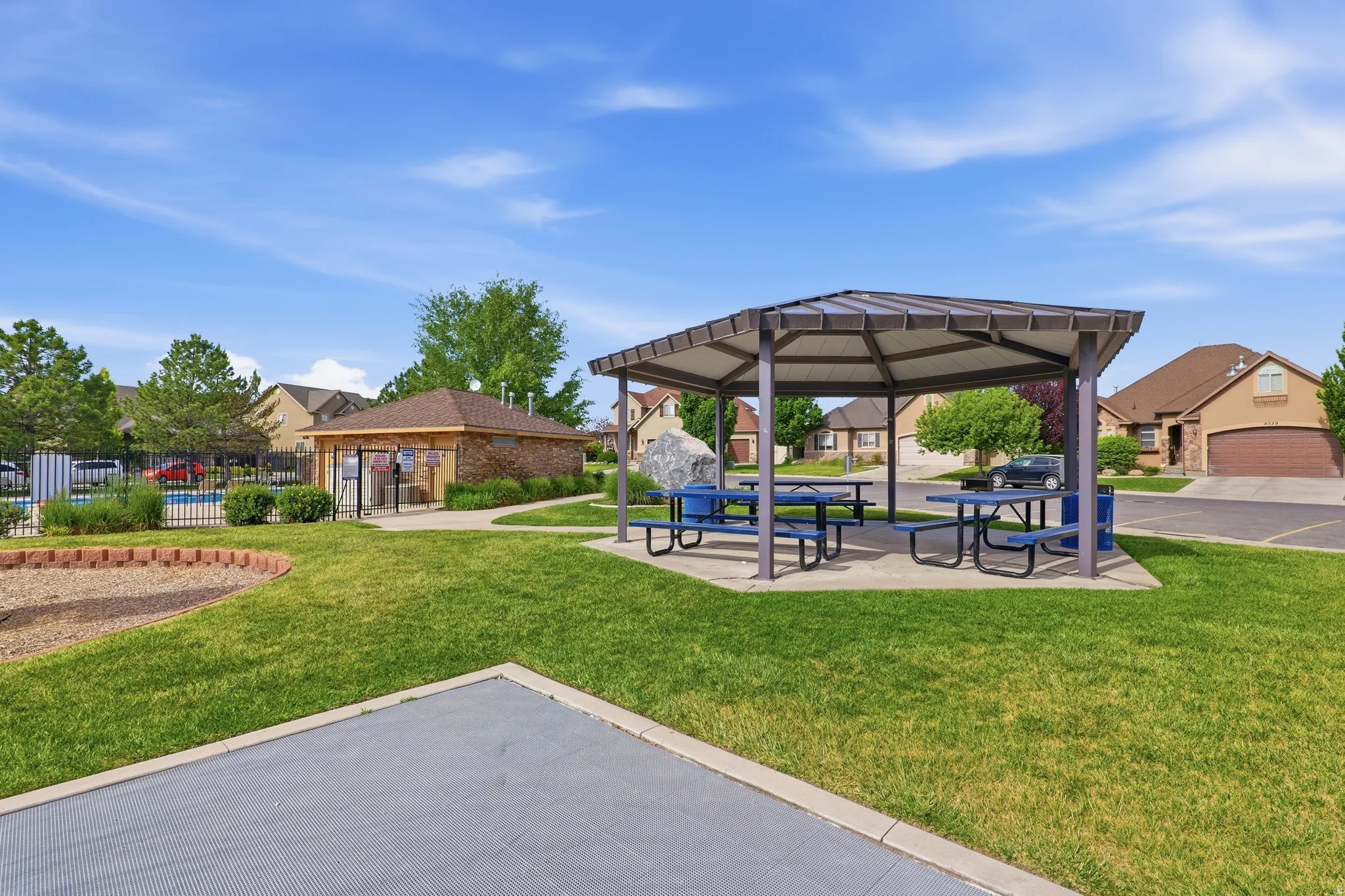 Community pavilion featuring multiple picnic tables