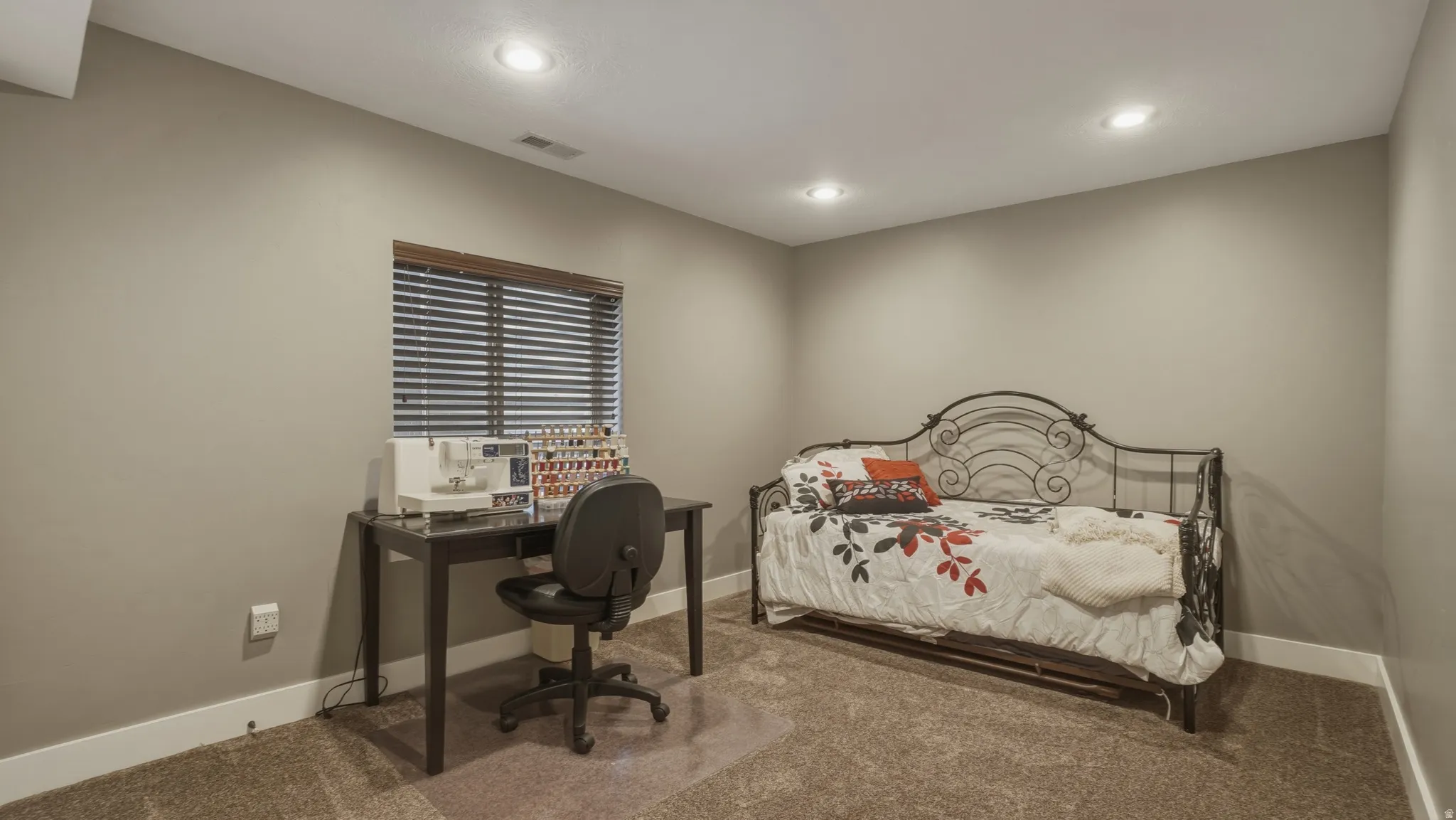 Bedroom with carpet flooring, recessed lighting, and an office area