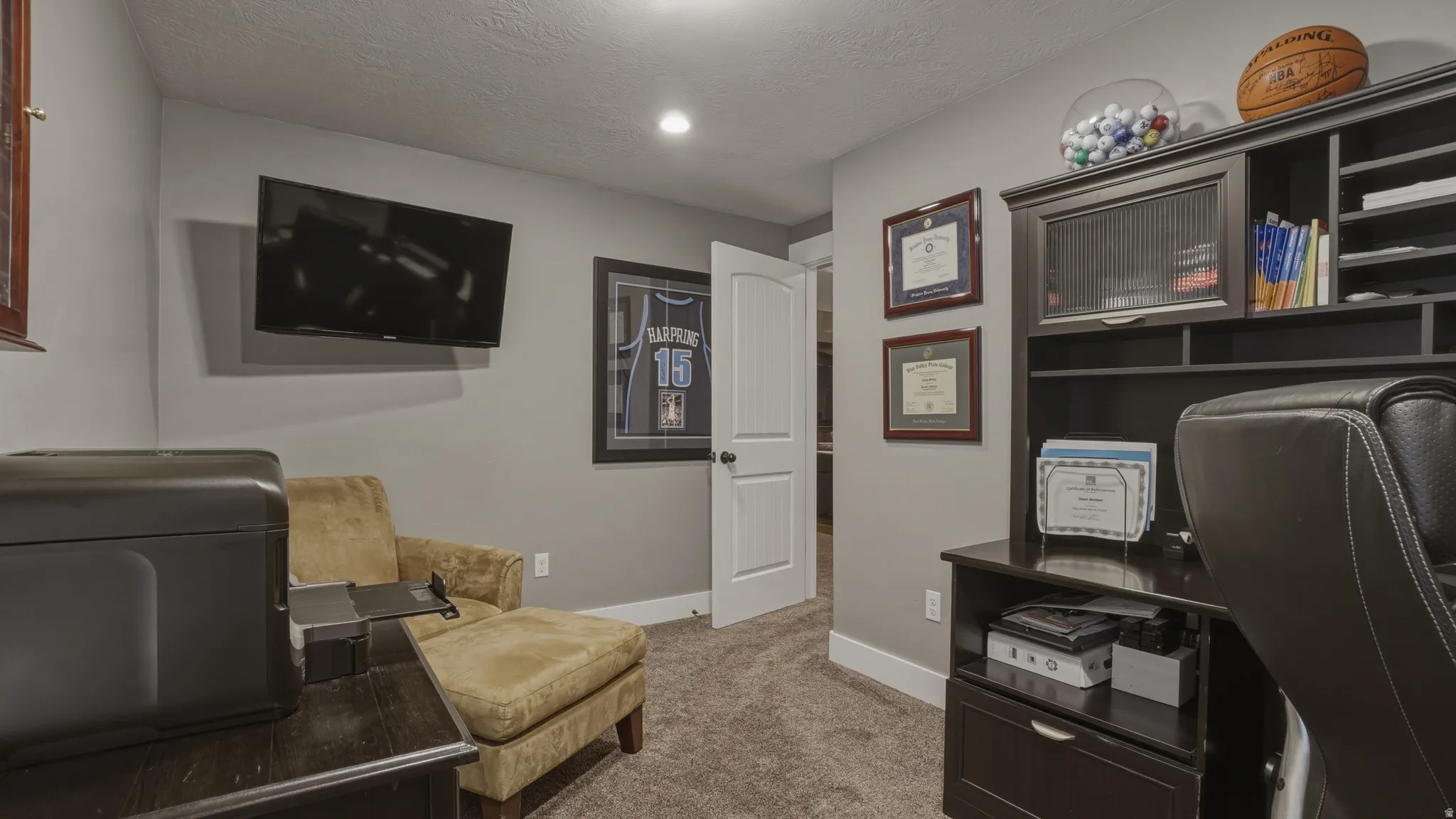 Office area with light carpet and a textured ceiling