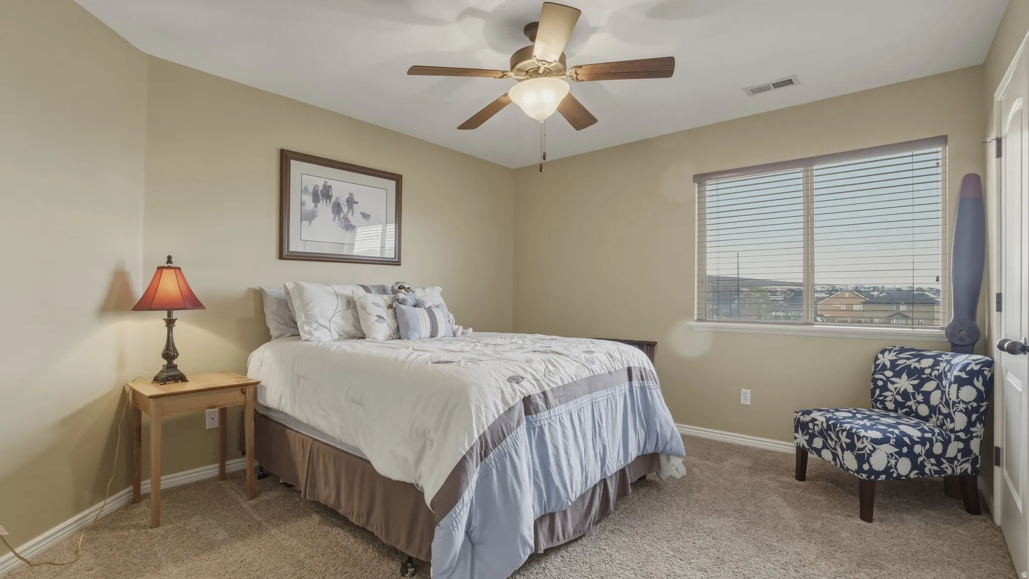 Bedroom with light carpet and ceiling fan