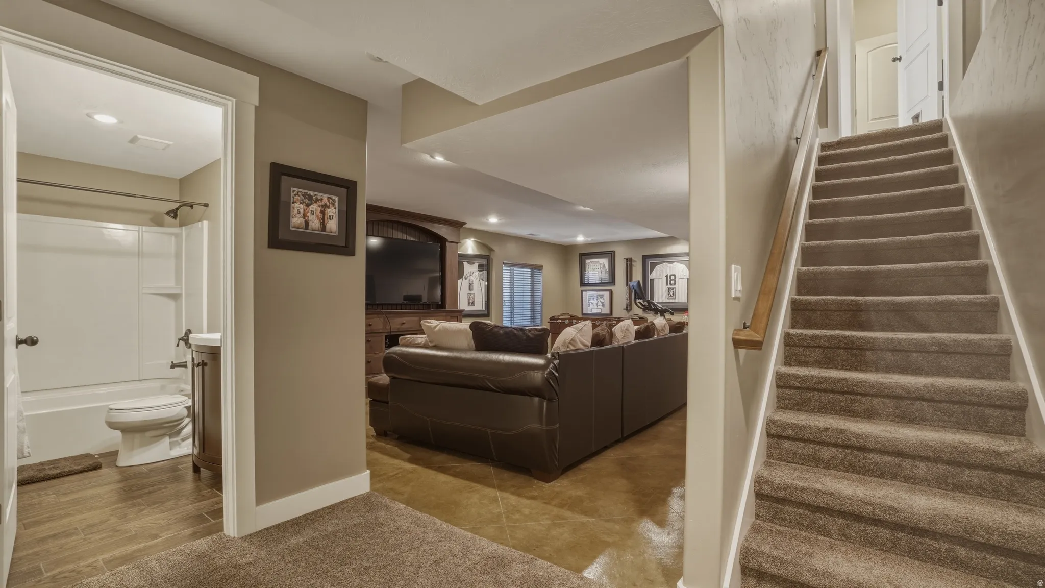 Staircase featuring recessed lighting and arched walkways