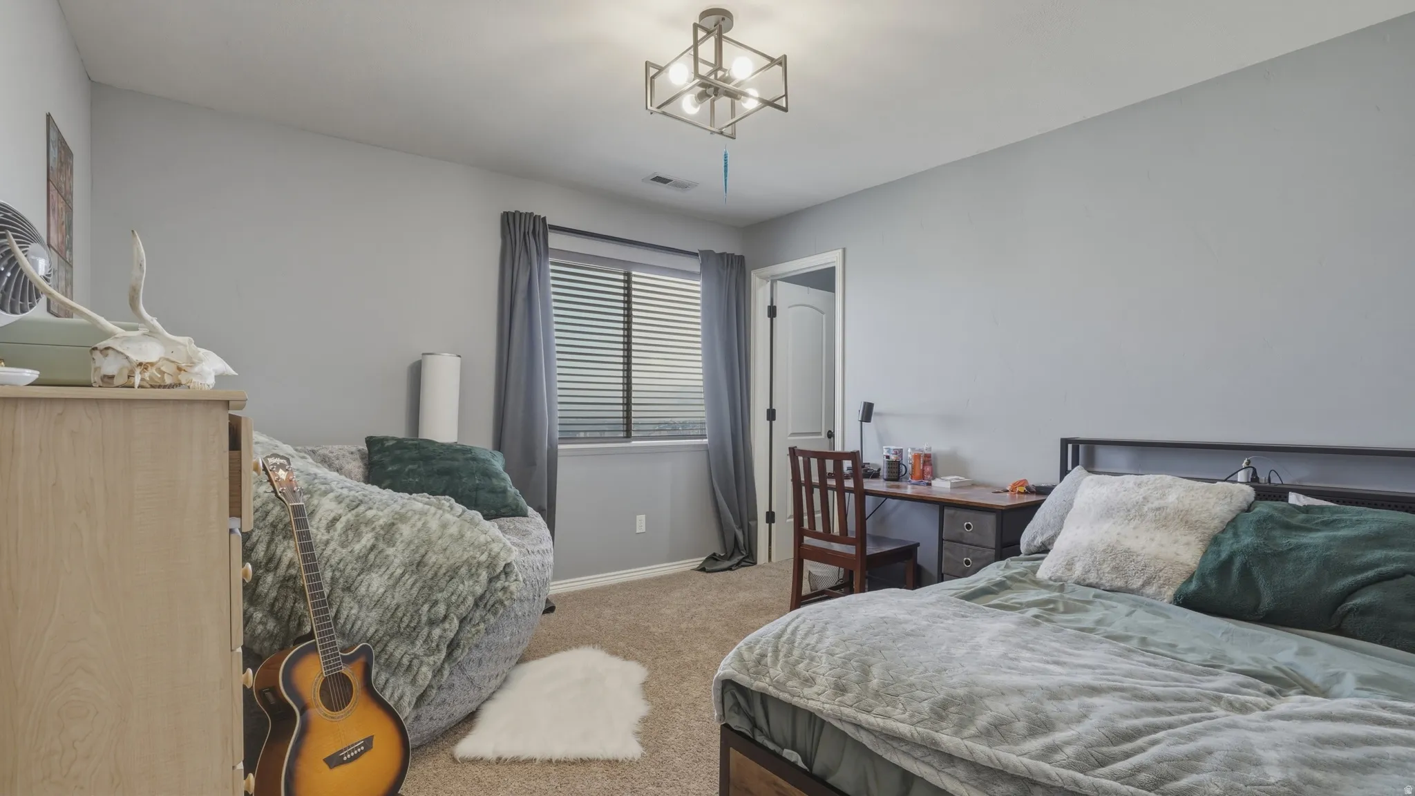 Bedroom featuring light colored carpet and baseboards