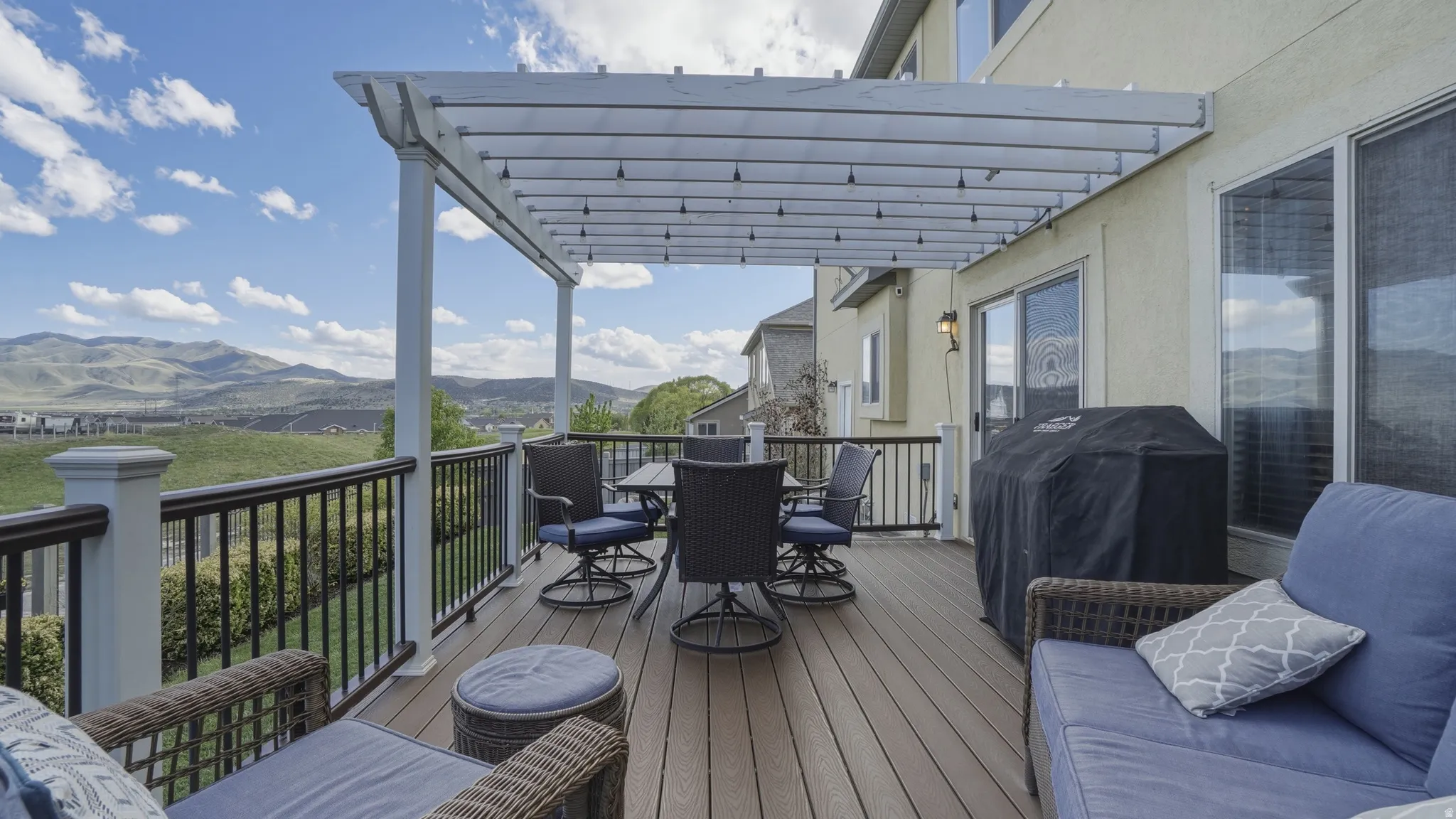 Deck with a pergola, outdoor dining space, grilling area, and a mountain view