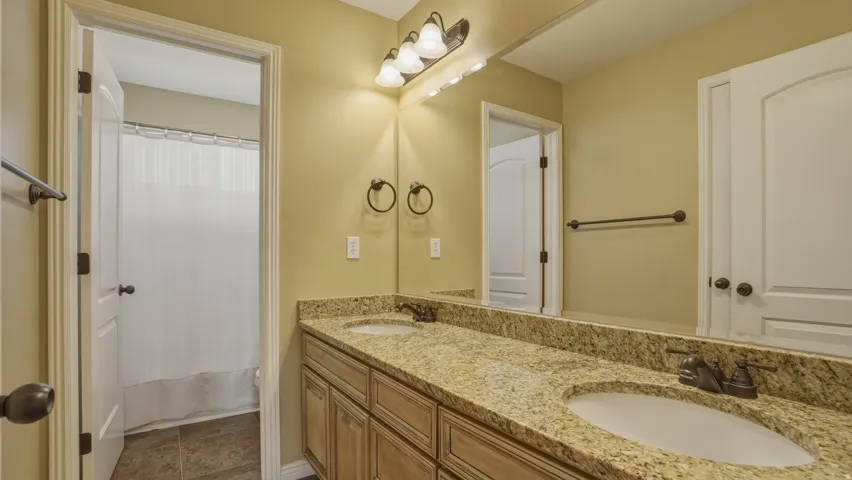 Bathroom with double vanity and shower / bath combo
