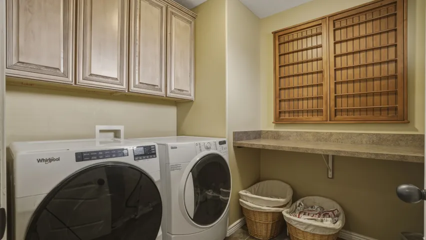 Laundry room featuring cabinet space and washing machine and clothes dryer
