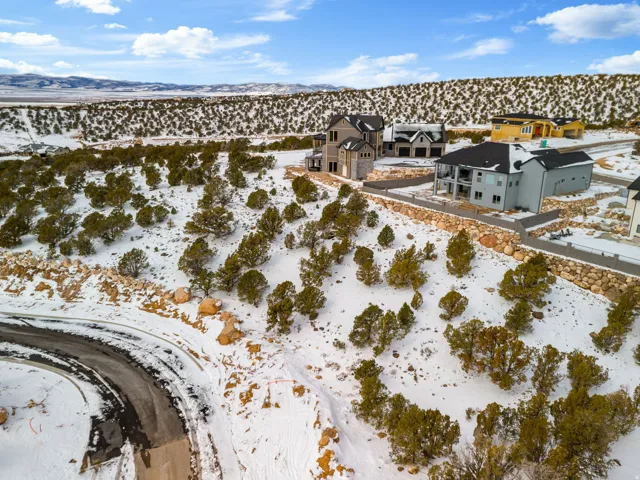 Snowy aerial view featuring a residential view and a mountain view