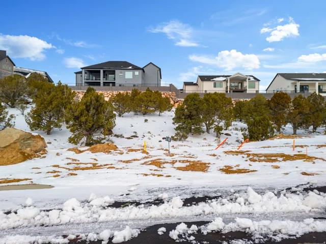 Snow covered rear of property featuring a residential view