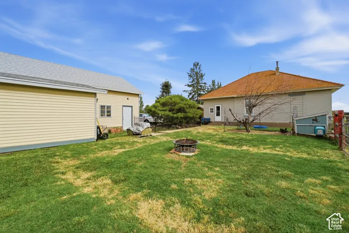 Expansive grass yard with a built-in fire pit