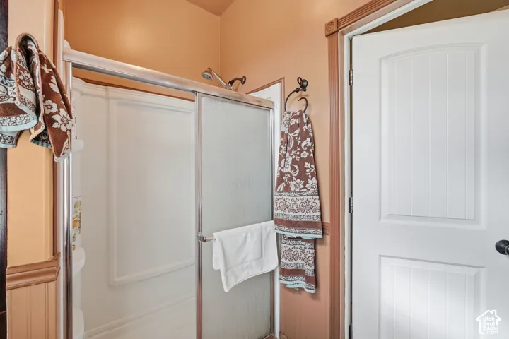 Shower enclosure with a chrome frame and textured glass sliding door