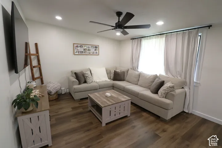 Living room featuring dark wood-type flooring, recessed lighting, and a ceiling fan