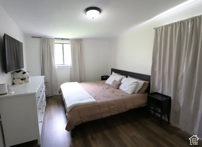 Bedroom featuring dark wood-style floors