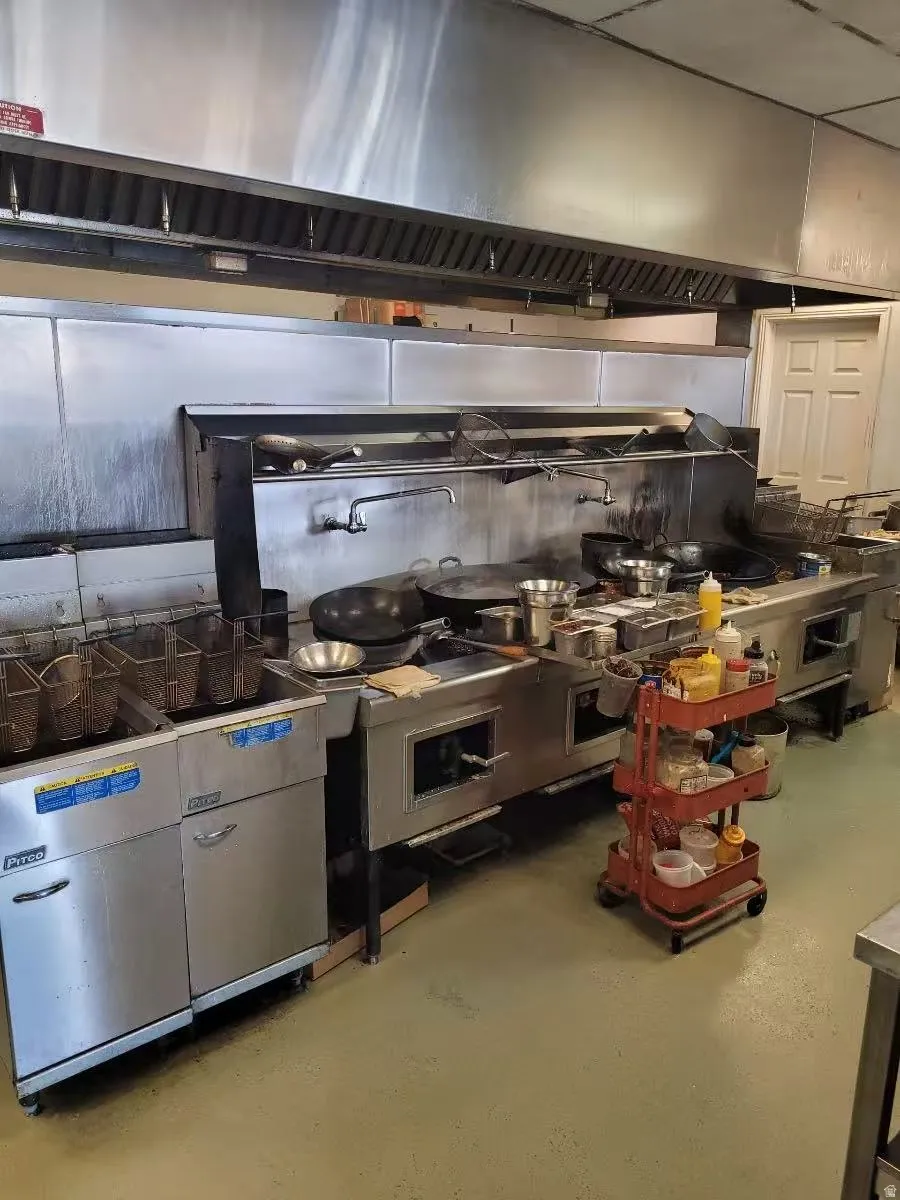 Kitchen with ventilation hood and finished concrete floors