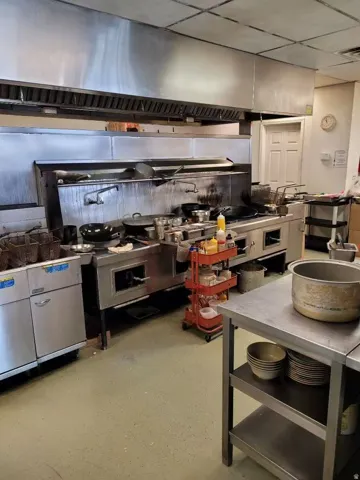 Kitchen featuring extractor fan and a paneled ceiling