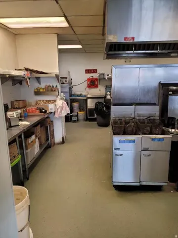 Kitchen with under cabinet range hood