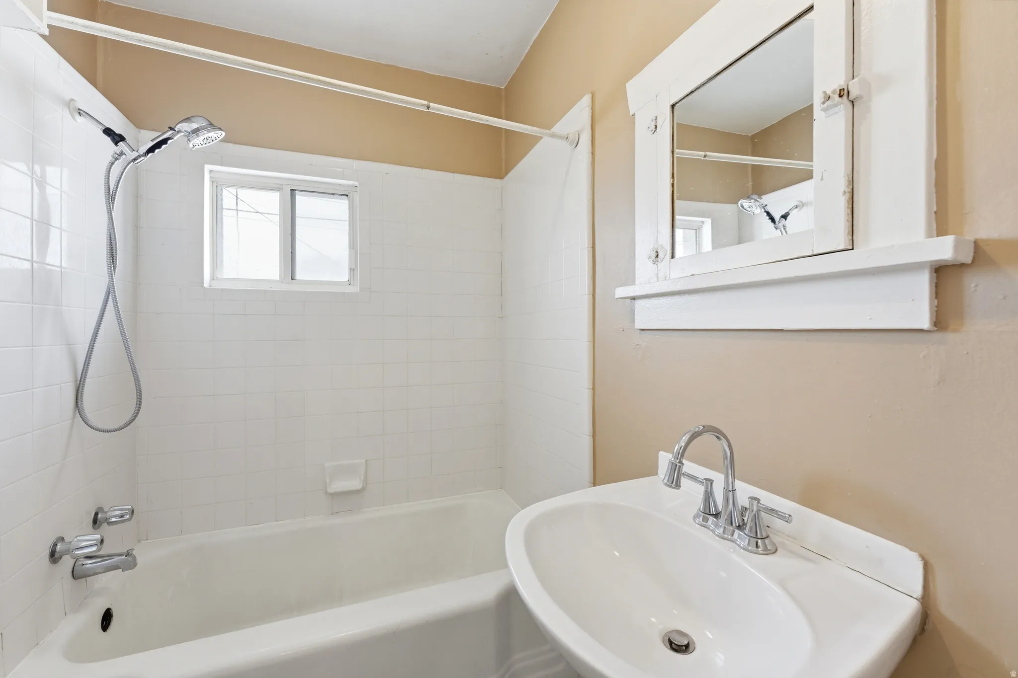 Bathroom featuring washtub / shower combination