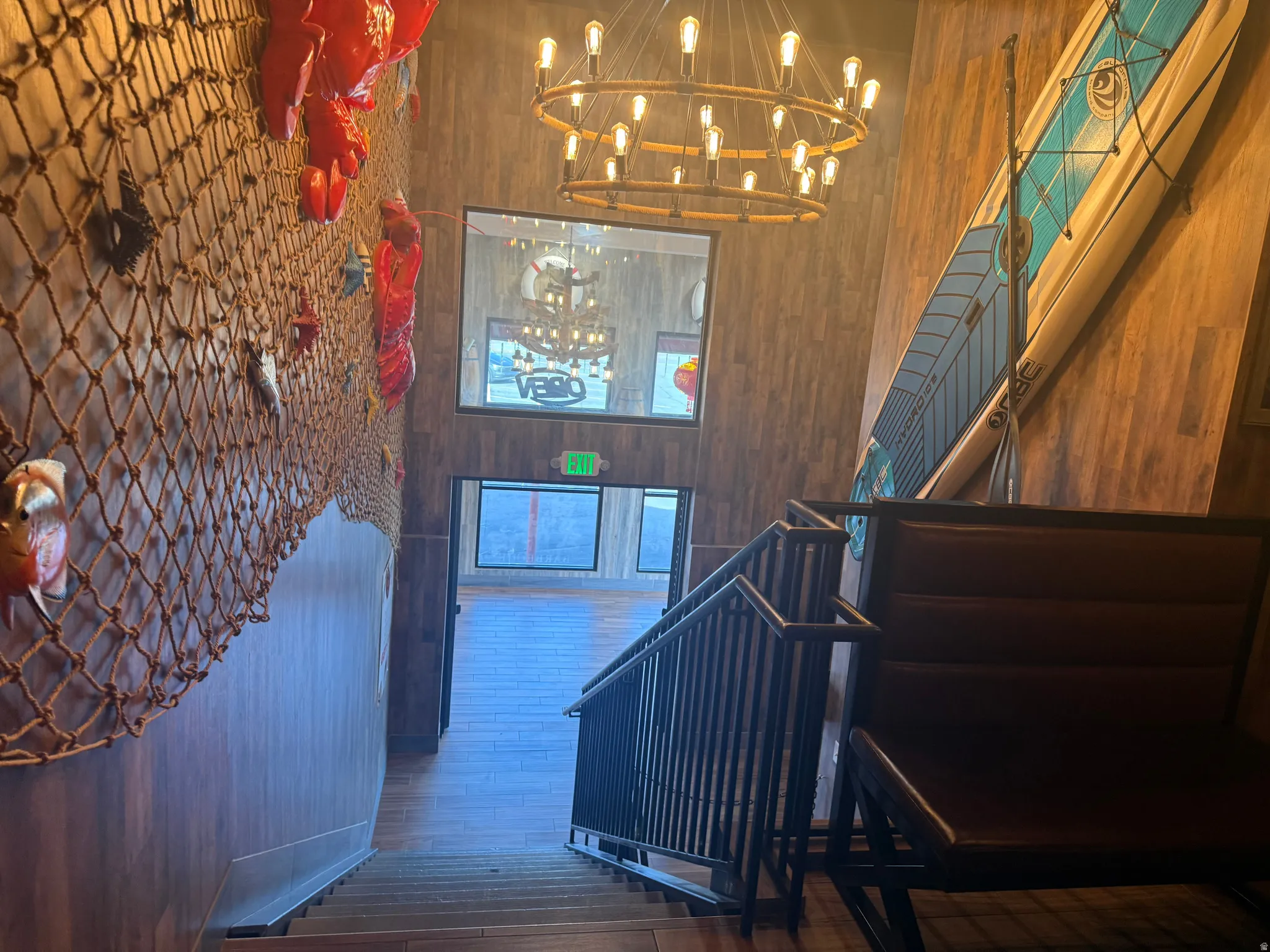 Stairs featuring wooden walls, hardwood / wood-style floors, and a high ceiling