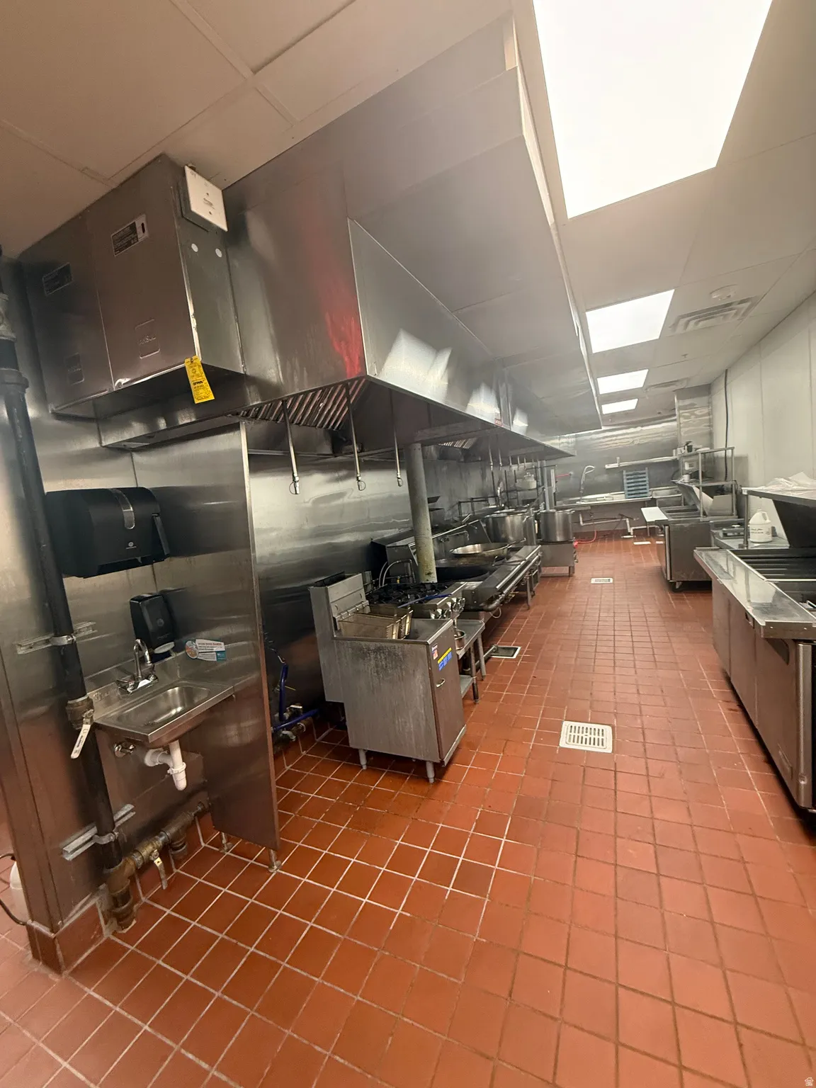 Kitchen with a drop ceiling and dark countertops