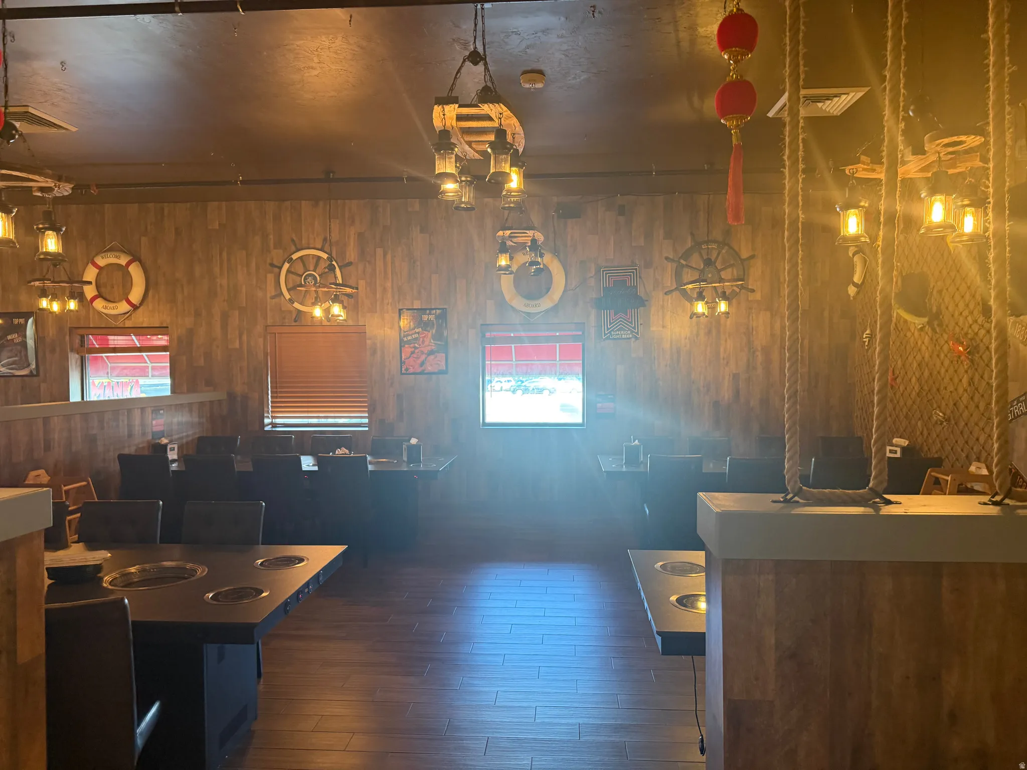 Dining room with dark wood finished floors and wooden walls