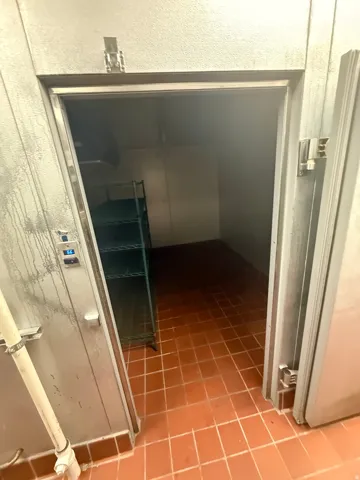 Corridor with light tile patterned floors