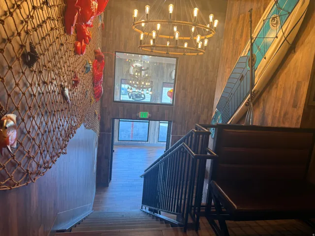Stairs featuring wooden walls, hardwood / wood-style floors, and a high ceiling