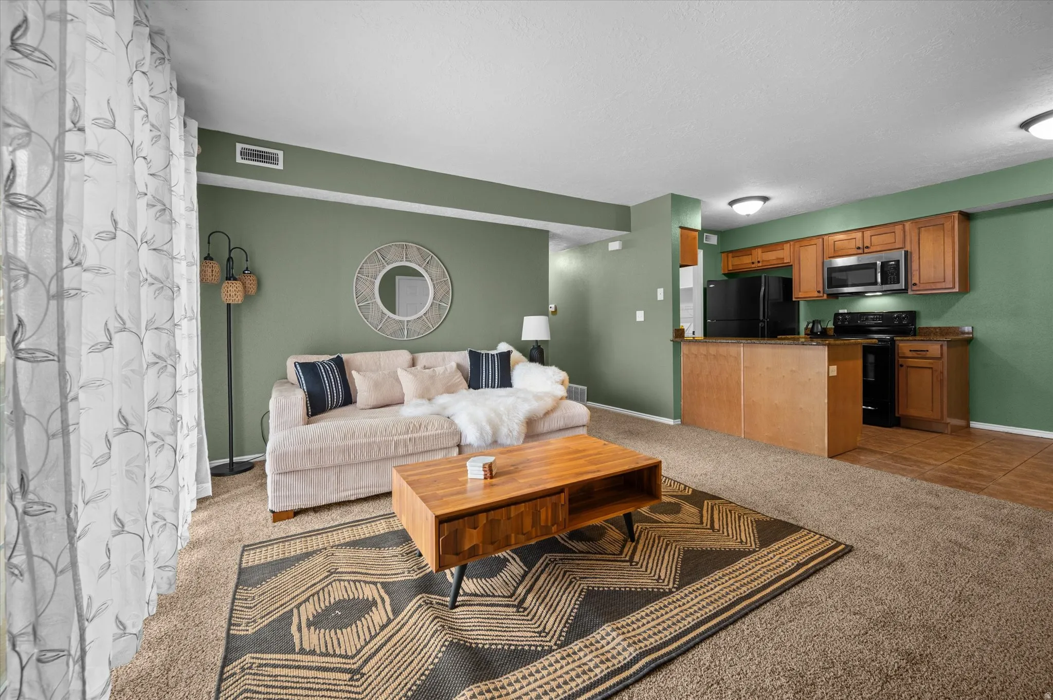 Living area featuring light colored carpet and light tile patterned floors