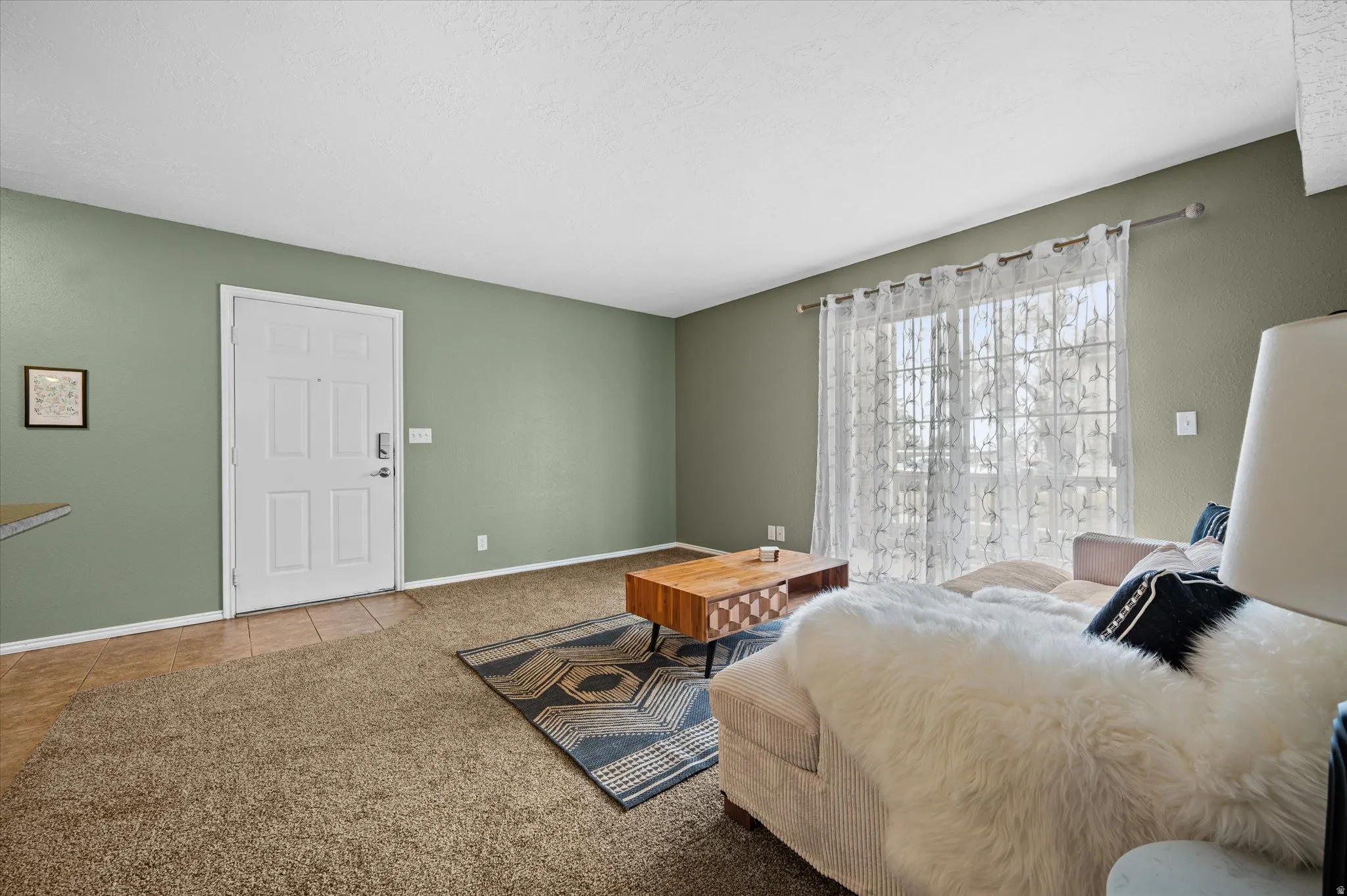 Bedroom with carpet flooring and tile patterned flooring