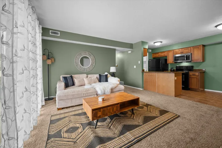 Living area featuring light colored carpet and light tile patterned floors