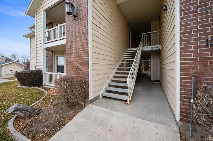 View of exterior entry featuring brick siding