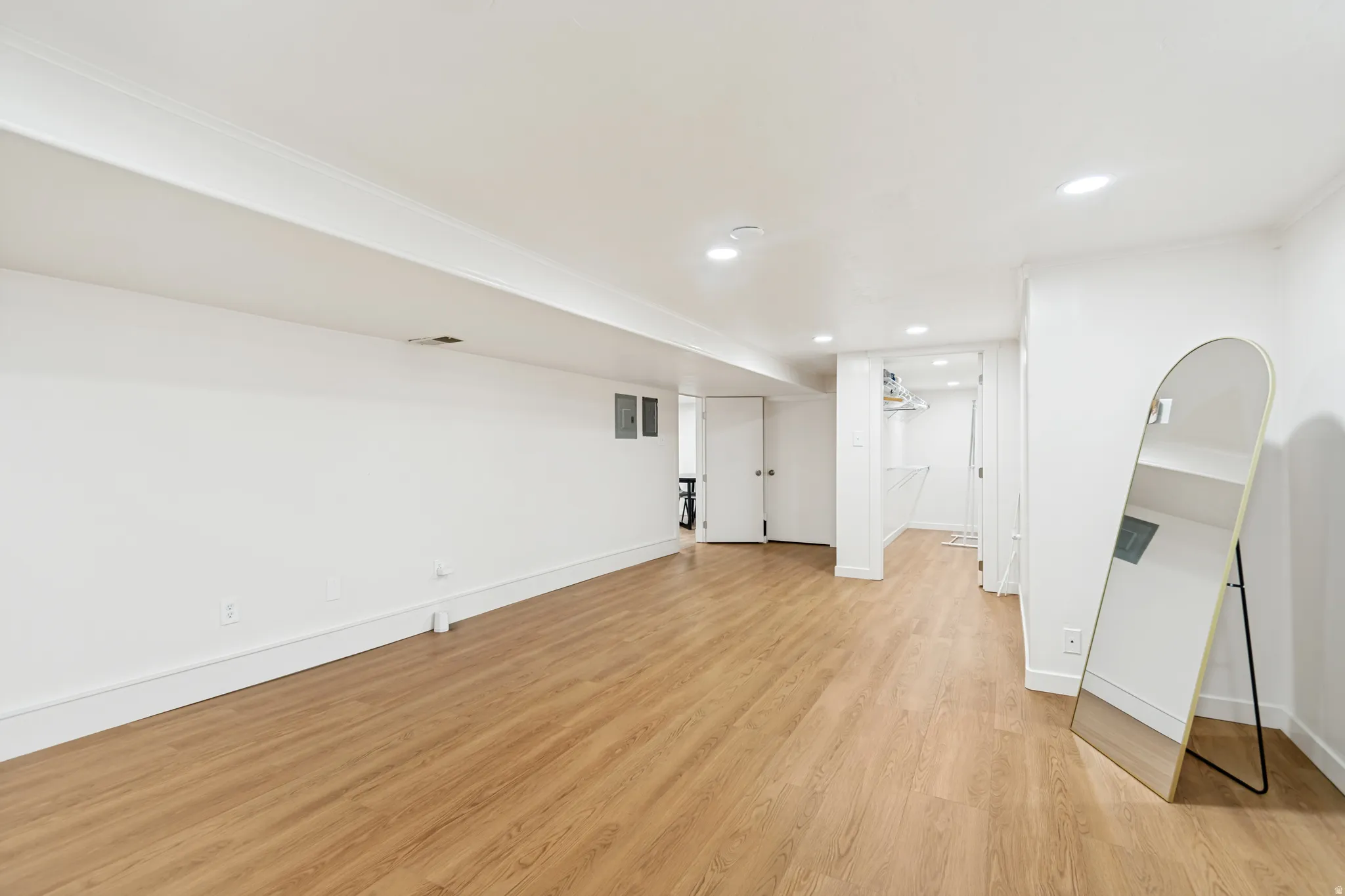 Finished below grade area featuring light wood-style floors and recessed lighting