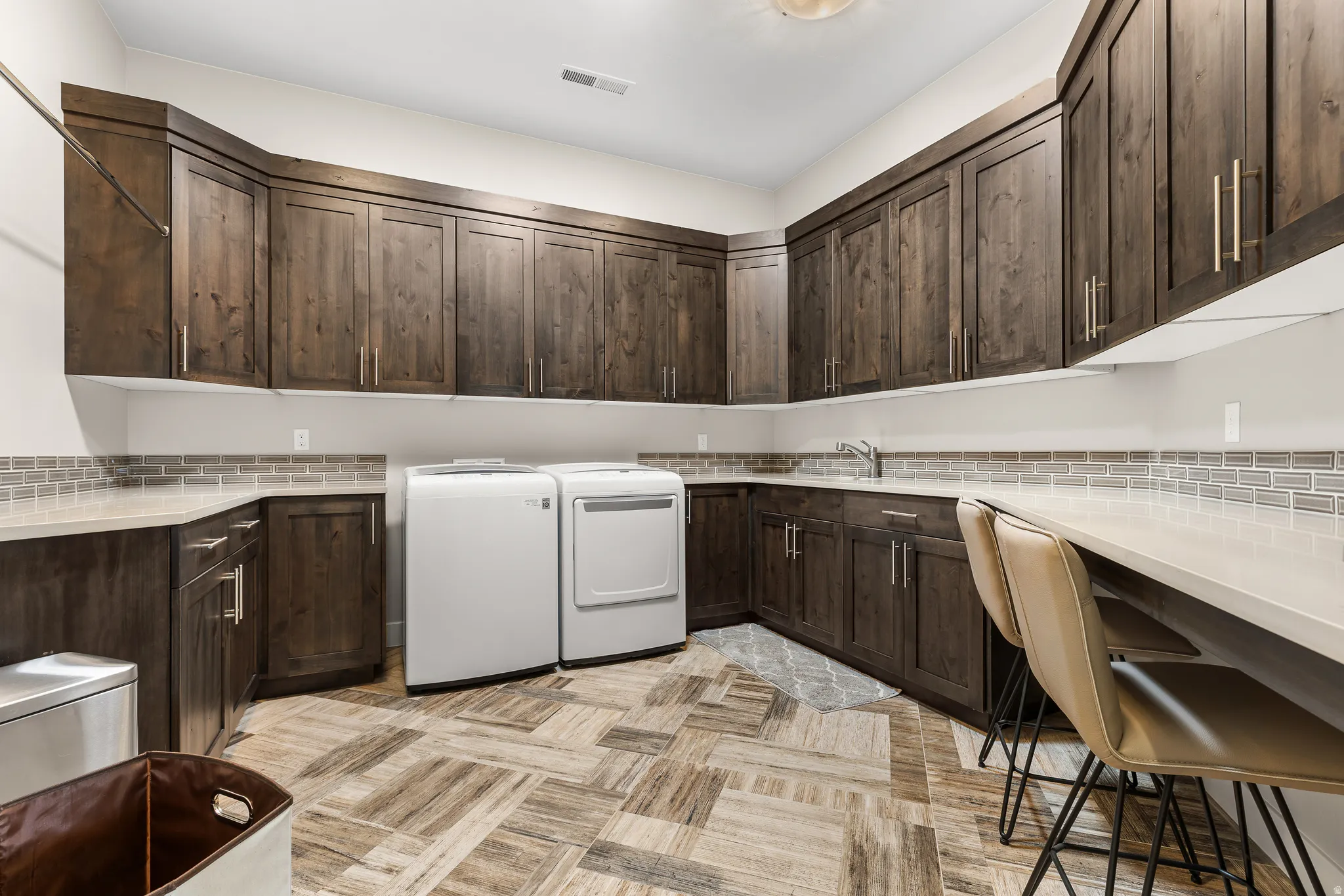 Laundry area with cabinet space and washing machine and clothes dryer