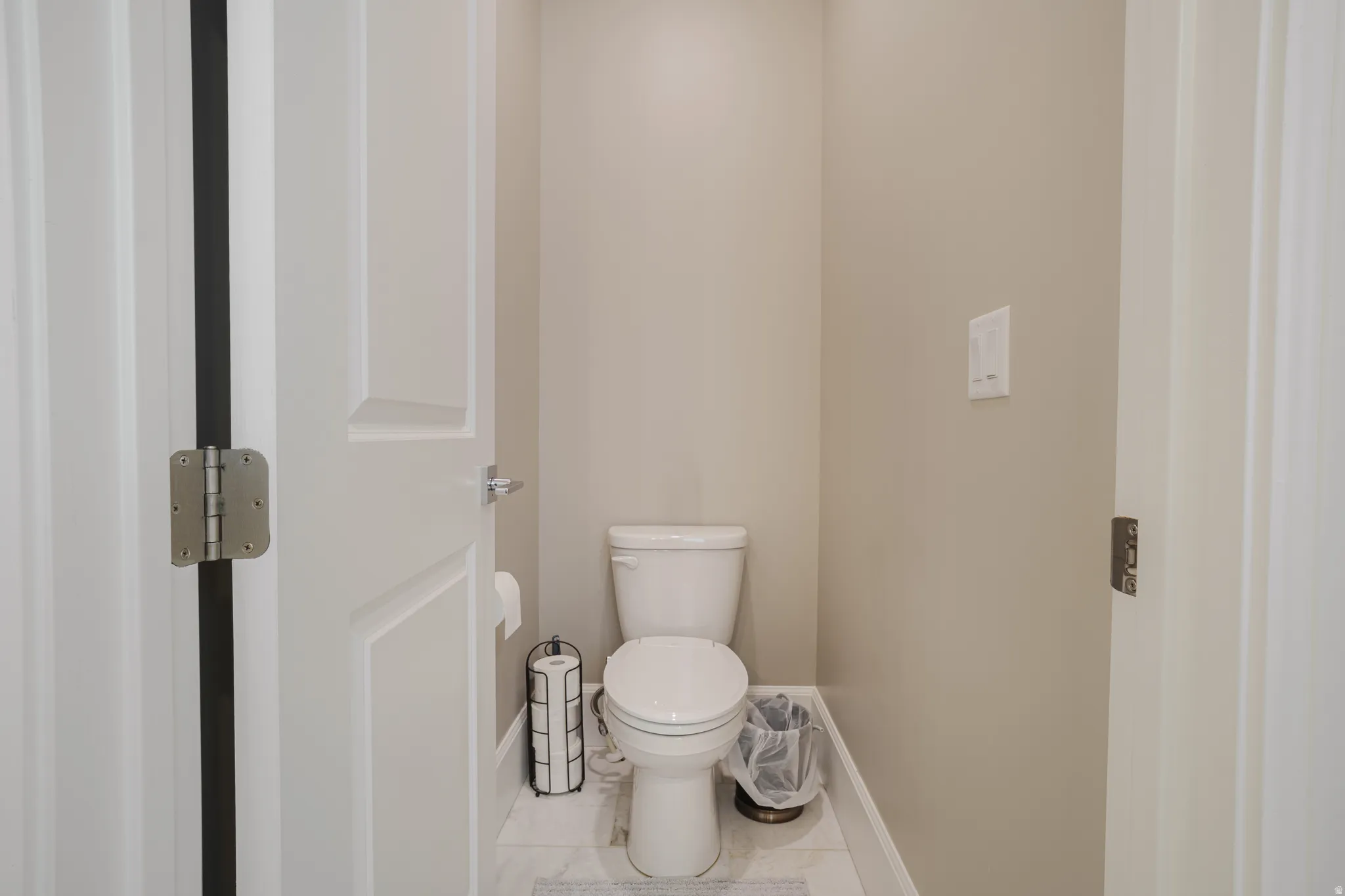 Bathroom with toilet and baseboards