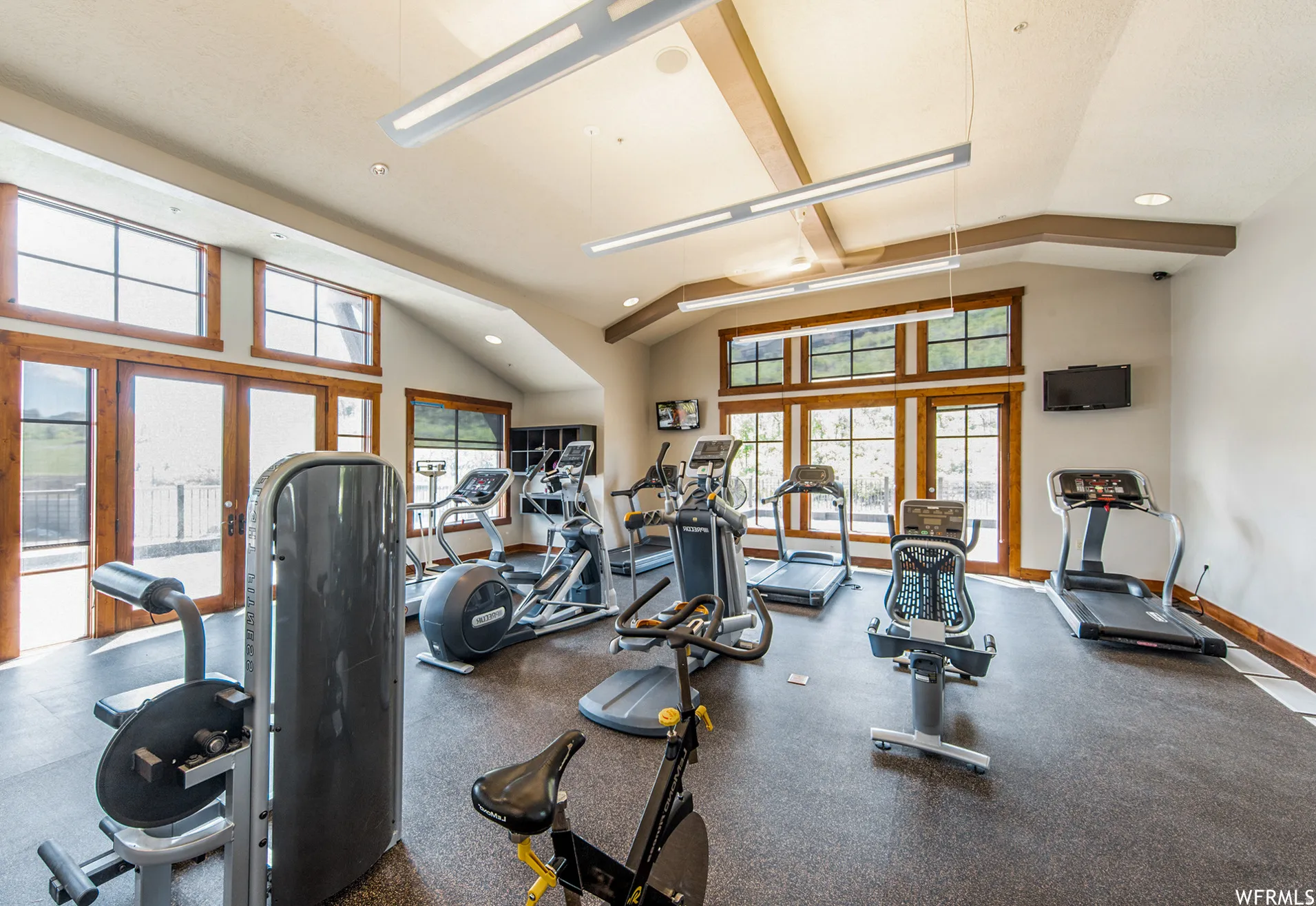 Gym featuring vaulted ceiling, recessed lighting, and french doors