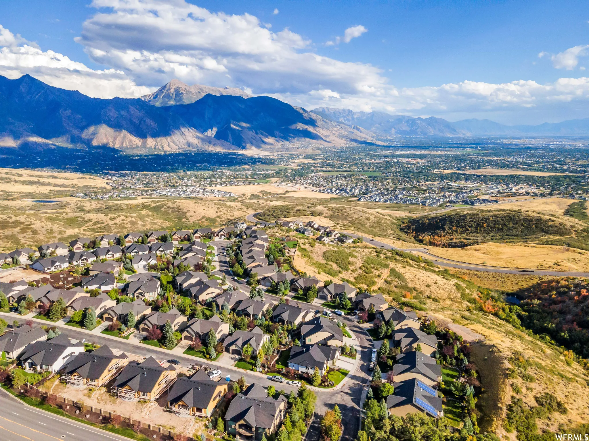Aerial view of residential area featuring a mountain backdrop