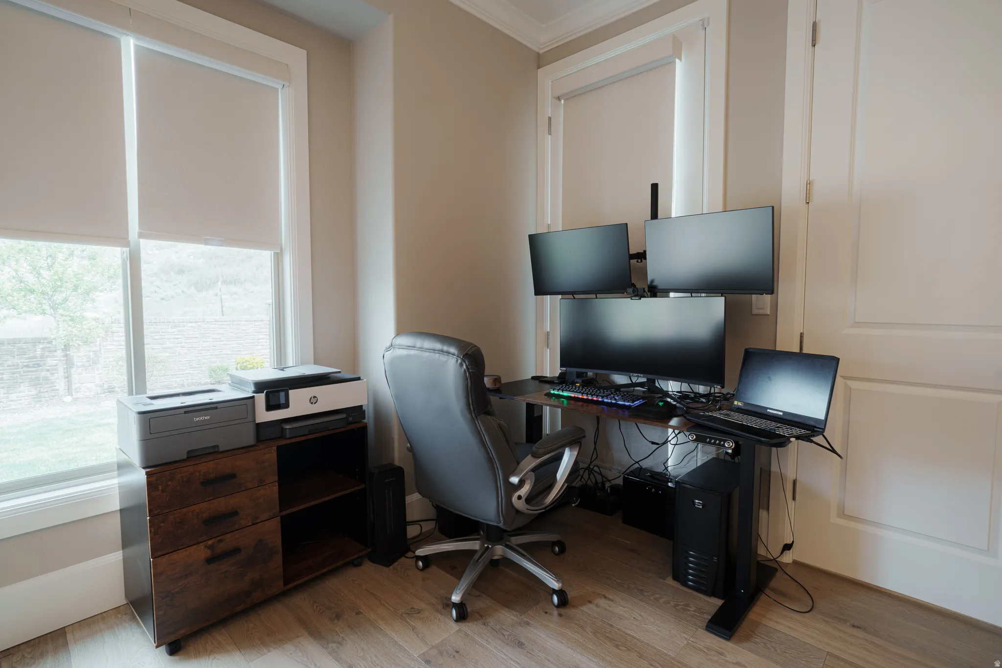 Office space with light wood-style floors and crown molding