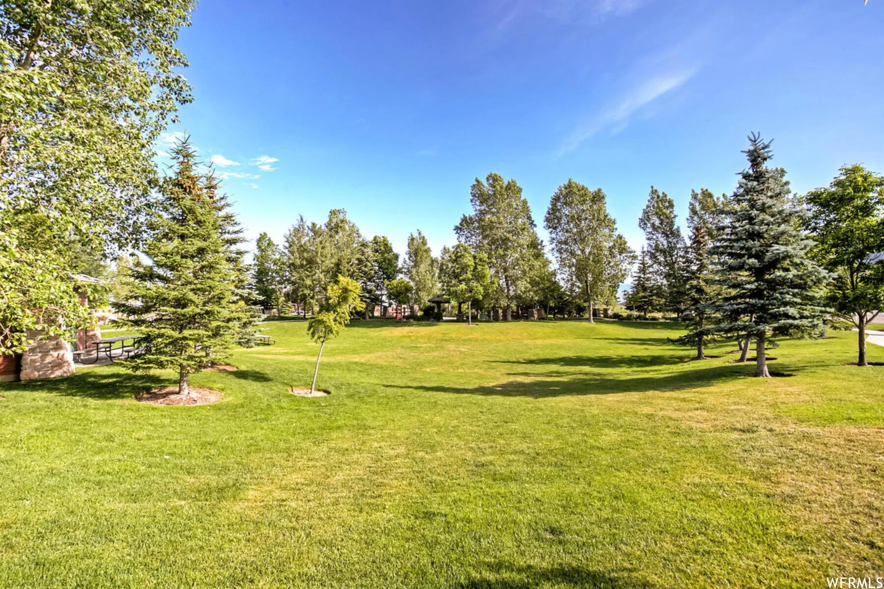 Surrounding community with view of wooded area