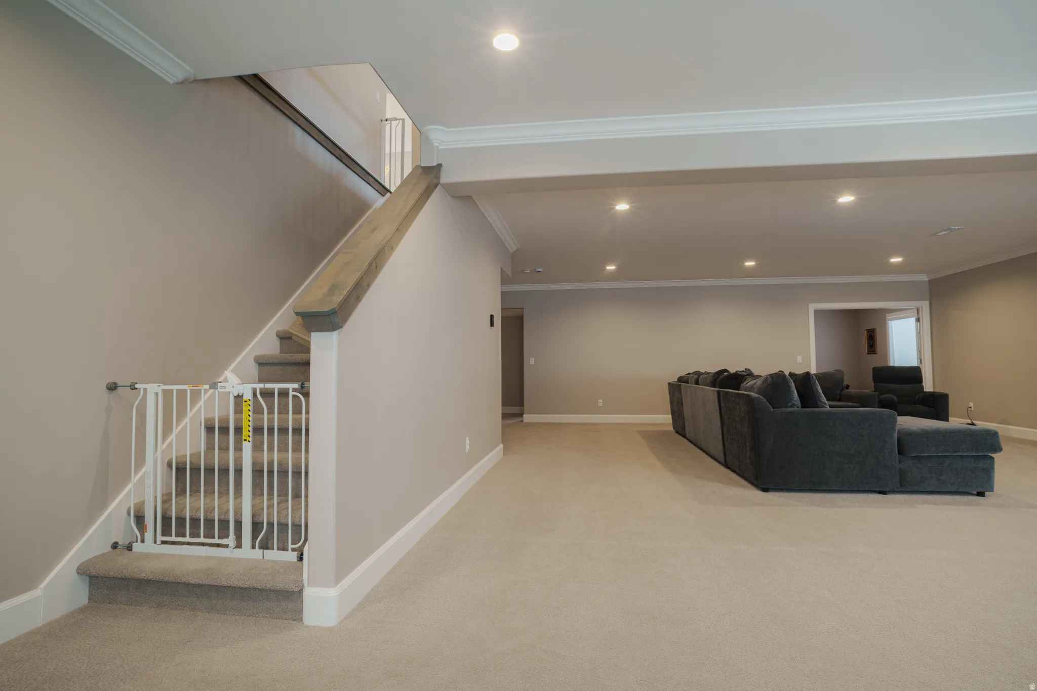 Living room featuring light carpet, crown molding, and recessed lighting