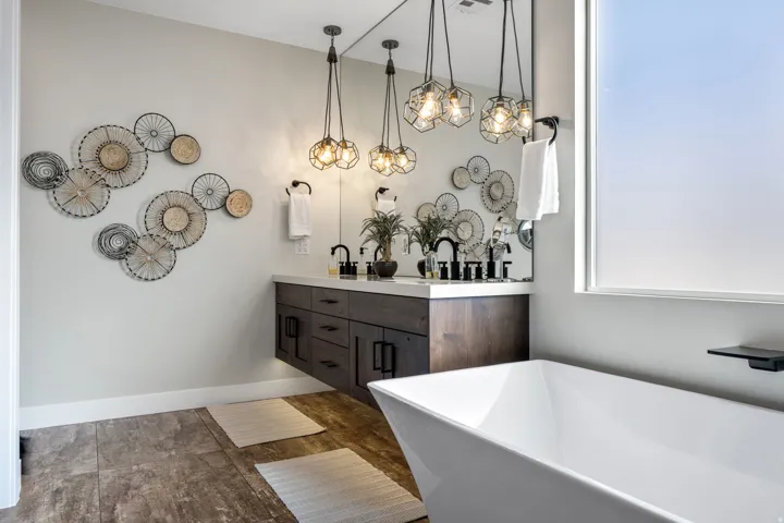 Full bath featuring double vanity and a soaking tub