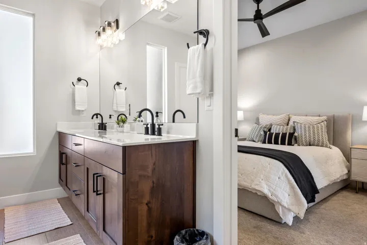 Bathroom featuring double vanity, ensuite bathroom, and ceiling fan