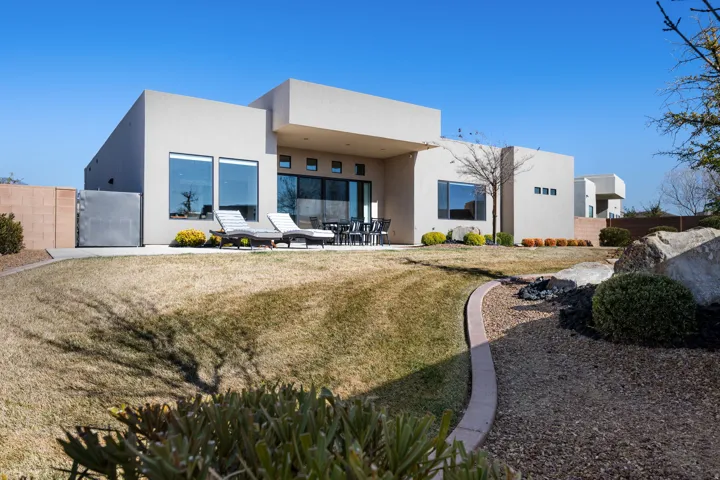 Rear view of property with stucco siding and a patio area