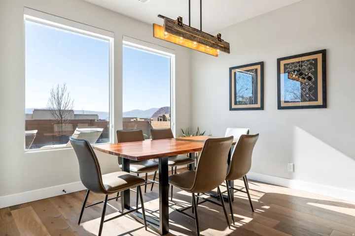 Dining room with hardwood / wood-style floors and a mountain view